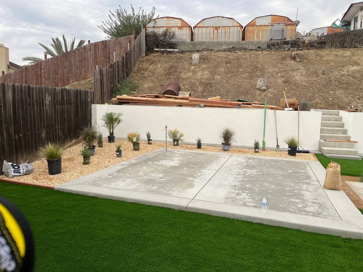 picture of a san diego california backyard with new concrete deck and artificial turf